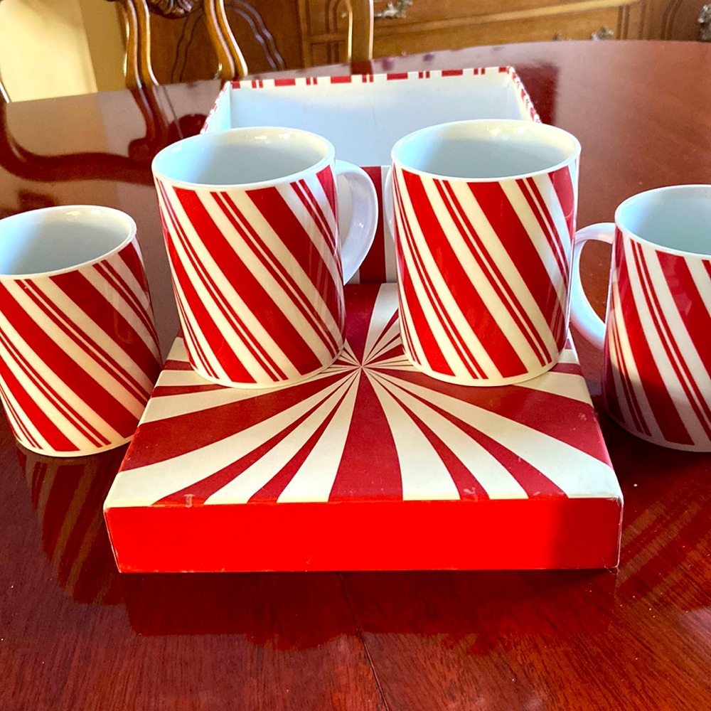 Set of four Christmas candy cane mugs.